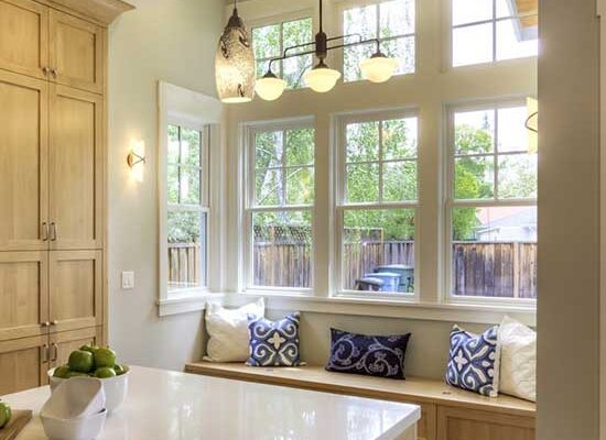Window Replacement services in IL - bright windows with a window seat in a bright home