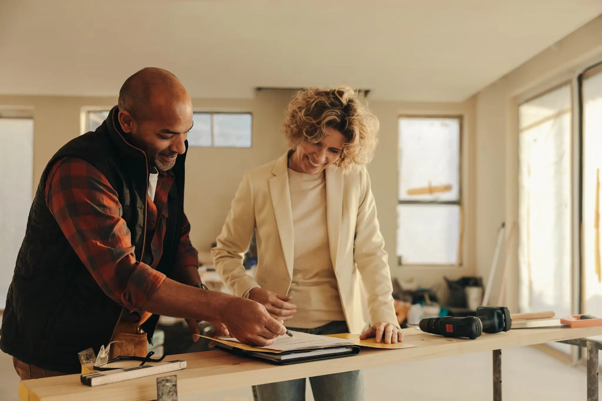 Contractor going over renovation paperwork with a homeowner